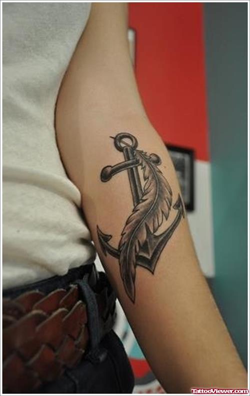 Grey Ink Anchor And Feather Tattoo On Left Arm