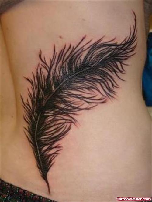 Black Ink Feather Tattoo On Back
