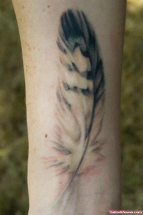 Grey Ink Feather Tattoo On Wrist