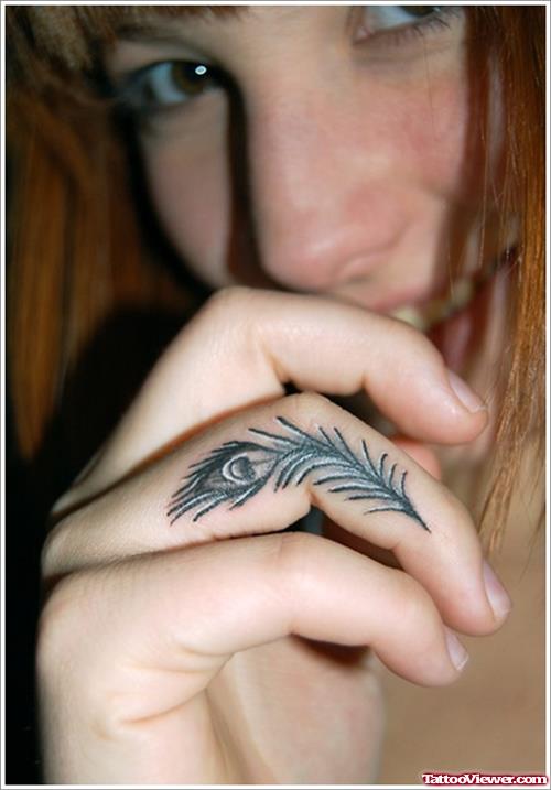 Small Peacock Feather Tattoo On Finger