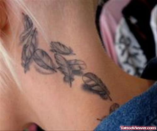Grey Ink Feathers Tattoos On Neck