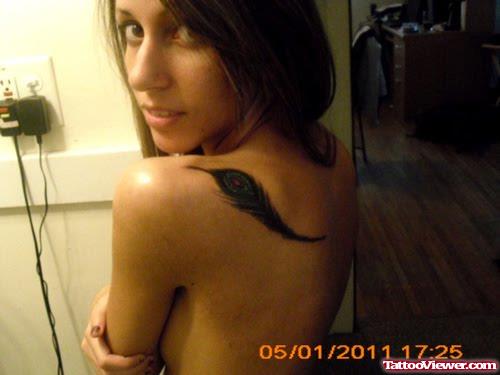 Feather Tattoo On Girl Upperback