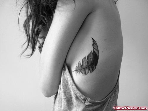 Girl with Feather Tattoo On Rib