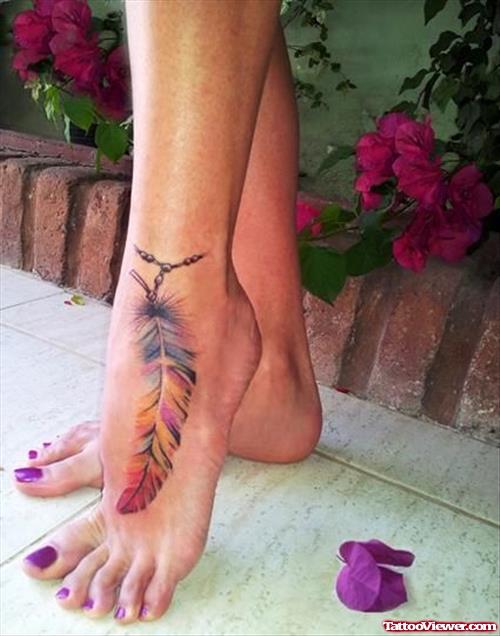 Colored Beautiful Feather Tattoo On Girl Left Ankle