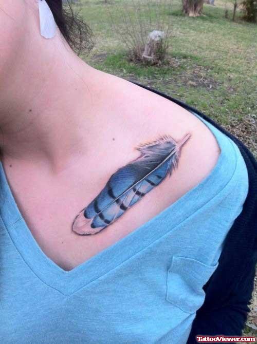 Blue Ink Feather Tattoo On Collrbone