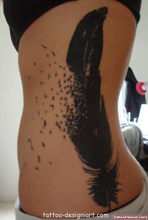 Black Ink Feather Tattoo On Rib Side