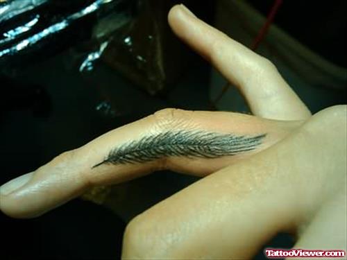 Small Feather Tattoo on Finger