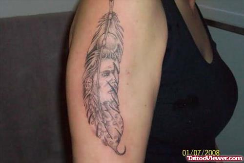 Face In Feather Tattoo On Bicep