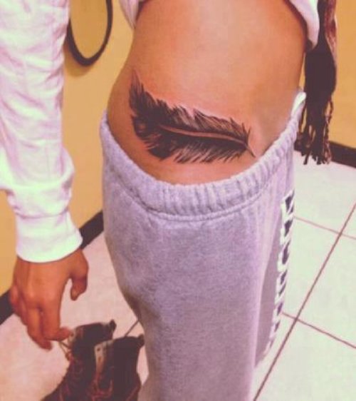 Amazing Girl Rib Feather Tattoo