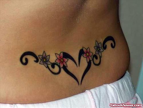 Flowers And Tribal Feminine Tattoo On Lowerback