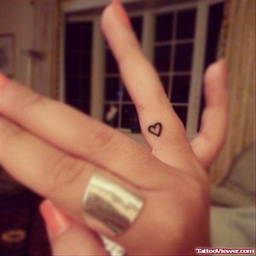 Tiny Heart Feminine Tattoo On Finger