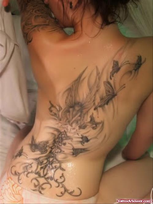 Grey Ink Fairy And Flying Butterflies Feminine Tattoo On Back