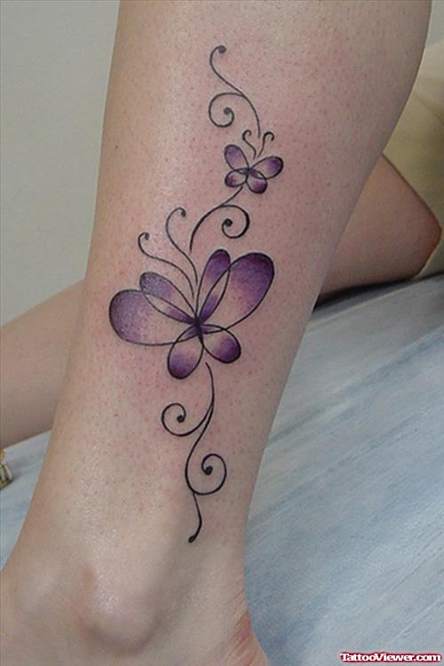 Purple Ink Feminine Tattoo On Leg