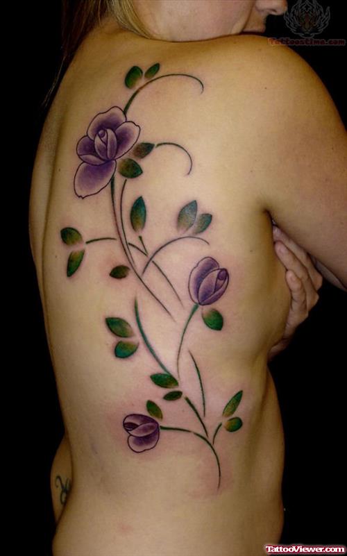 Purple Ink Feminine Tattoo On Girl Rib Side