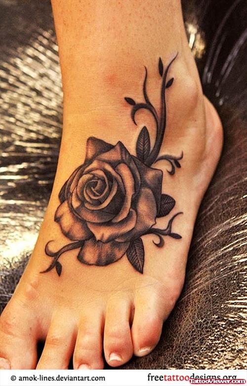 Grey Ink Rose Flower Feminine Tattoo On Left Foot