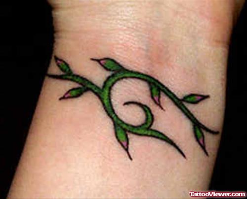 Green Ink Feminine Tattoo On Wrist