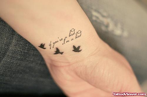 Flying Birds And Lettering Tattoo On Wrist