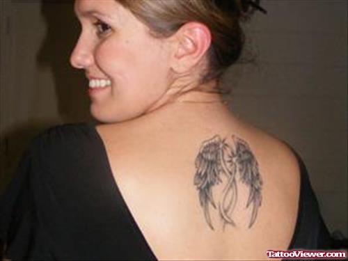 Grey Ink Feminine Tattoo On Upperback