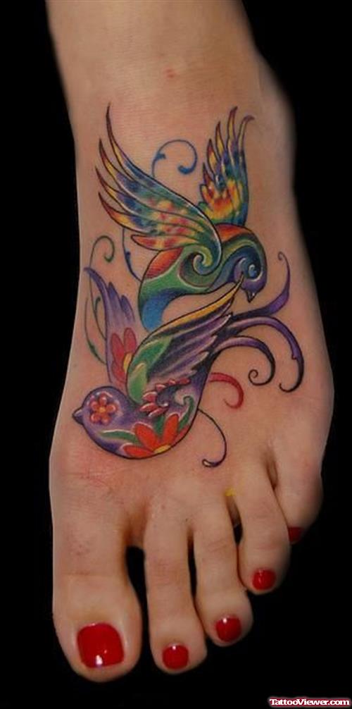 Colored Flying Birds Feminine Tattoo On Girl Left Foot