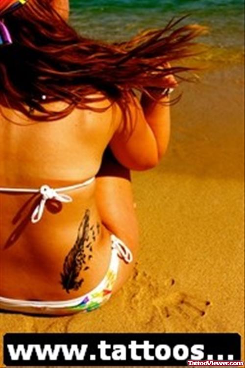 Awesome Birds Flying From Feather Feminine Tattoo On Back