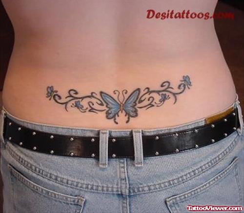 Attractive Blue Ink Butterfly Feminine Tattoo On Lowerback
