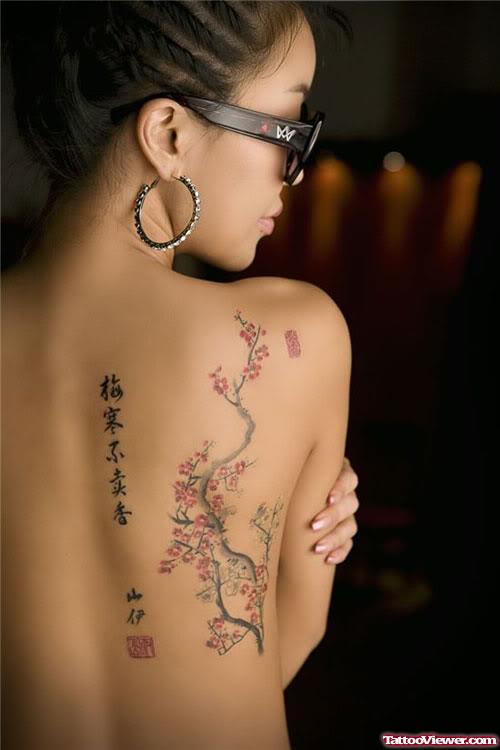Chinese Symbols And Japanese Flowers Feminine Tattoo On Back