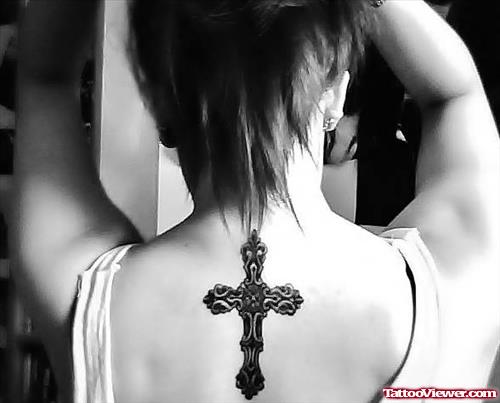 Black Ink Cross Feminine Tattoo On Upperback