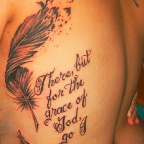 Grey Ink Feather And Lettering Tattoo On Back