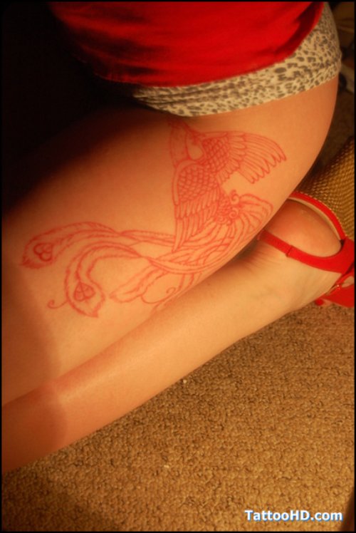 Red Ink Feminine Phoenix Tattoo On Leg Bicep