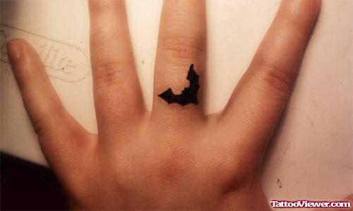 Tiny Black Bat Finger Tattoo