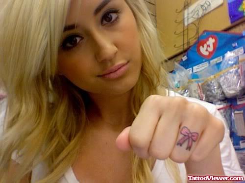 Girl Showing Her Bow Finger Tattoo