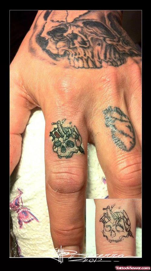 Grey Ink Skull Finger Tattoo