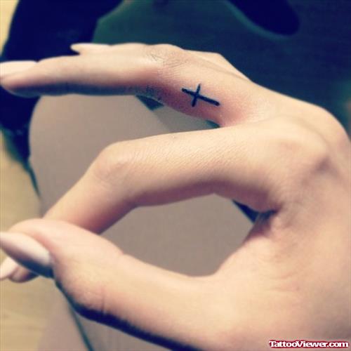 Tiny Black Cross Finger Tattoo