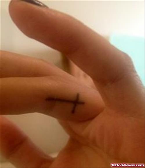 Small Cross Finger Tattoo