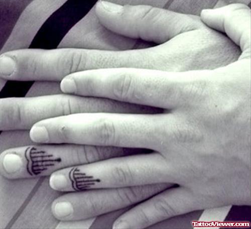 Matching finger tattoos