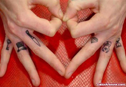 Diamond And Knife Finger Tattoo