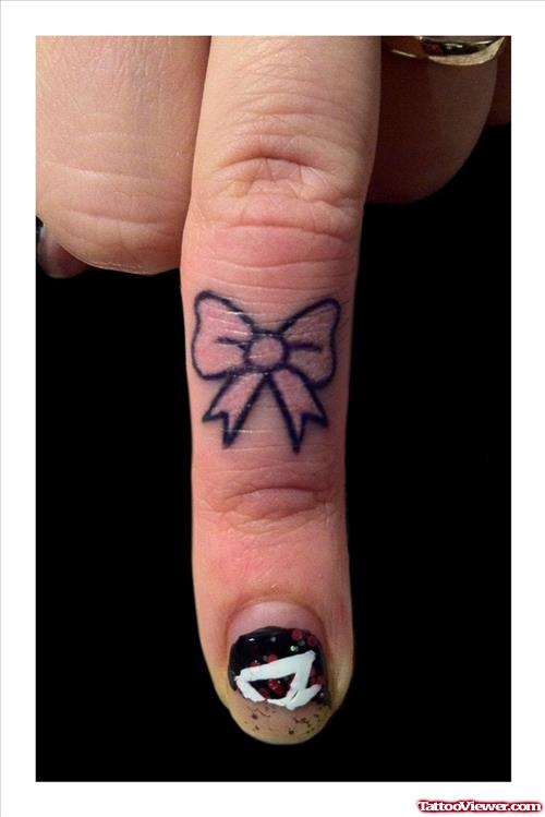 Attractive Black Ink Bow Finger Tattoo