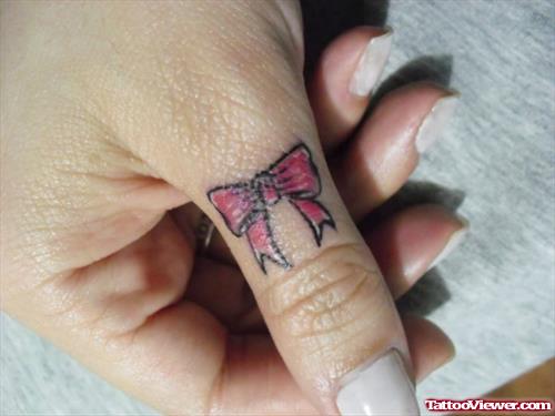 Attractive Red Ink Bow Finger Tattoo
