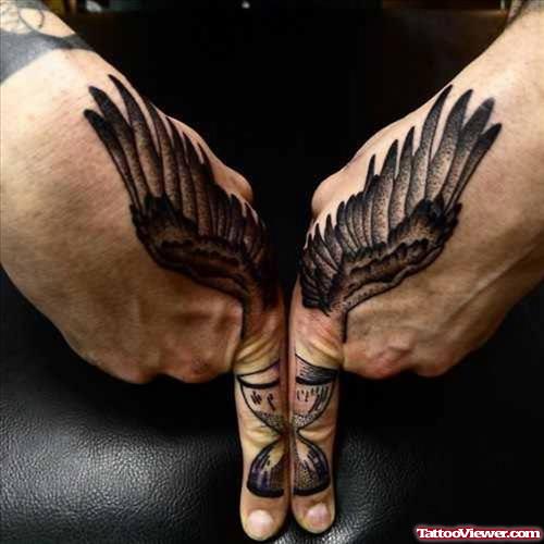 Grey Ink Wings And Hourglass Finger Tattoo