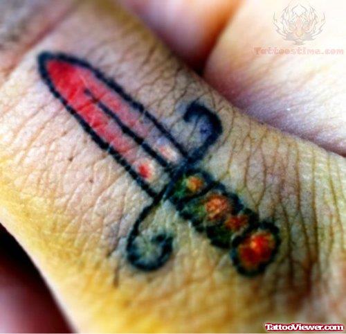 Small Dagger Tattoo On Finger