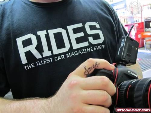 Smile Tattoo On Cameraman Finger