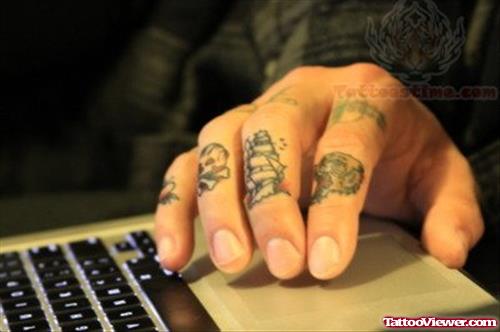 Skull And Ship Tattoo On Fingers