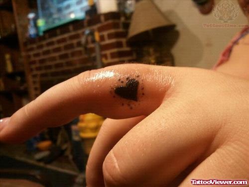 Black Tiny Heart Tattoo On Finger