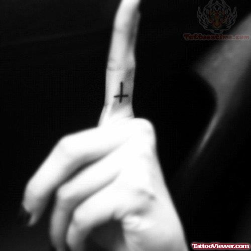 Small Black Cross Tattoo On Finger