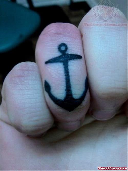 Black Ink Anchor Tattoo On Finger