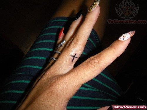 Tiny Cross Tattoo On Finger