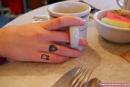 Diamond And Teeth Tattoo On Finger