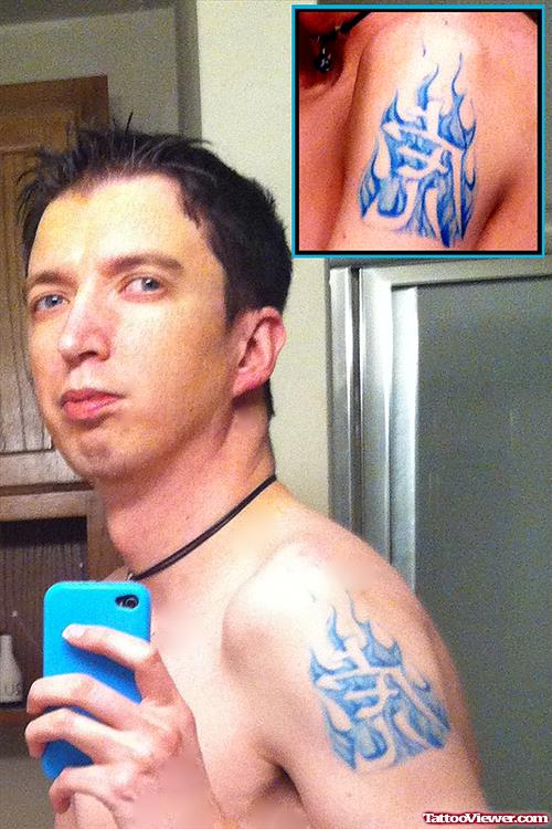 Blue Ink Fire Flame Tattoo On Left Shoulder