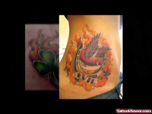 Flying Bird With Evil Banner Fire Flame Tattoo On Side Rib