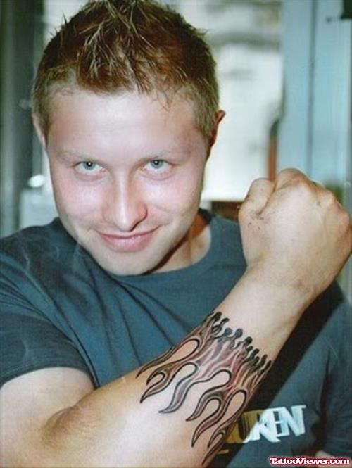 Man With Flames Tattoo On Forearm